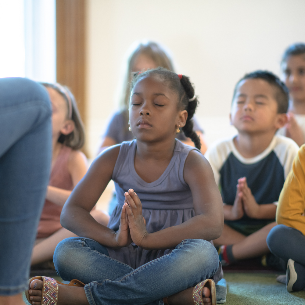 Children meditating in school