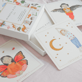 Yoga cards spread on a bed showing the Butterfly, Crescent Moon and Eagle poses