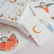 Yoga cards spread on a bed showing the Butterfly, Crescent Moon and Eagle poses