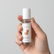 Hand holding the I Am Calm essential oil roll on bottle, labelled with a puppy illustration