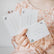 Child holding a fan of Love Notes cards including Shoot for the moon and You're kind, clever and fun