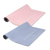 Two kids yoga mats rolled open, one pink and one blue grey, with the Mindful and Co Kids wordmark