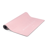 The pink kids yoga mat partly rolled out