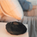 Black Zenimal teen adult device on a white surface with a blurred background