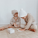 Two children laying out yoga snap cards on the floor beside the box