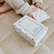 Child lifting cards from the open Yoga Snap Game box