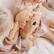 Child sitting on a bed hugging the weighted puppy against their chest
