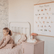 The Yoga Poses print hanging above a pink nightstand in a child's bedroom