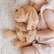 Toddler lying on a bed hugging the golden weighted puppy