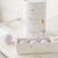Tube of magnesium calming soak on a counter beside an open box of three lavender bath fizzies.