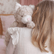 Girl seen from behind carrying the weighted cat over her shoulder