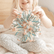 Child holding the closed magic ball in both hands, ready to expand it