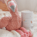 The Magnesium Calming Soak tub on a bed beside a pink plush flamingo