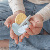 Child's cupped hands holding several textured worry stones