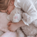 Girl lying on a striped pillow with her arm around the weighted cat