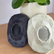 Two Zenimal+ devices, one dark blue and one cream, on a wooden table beside a potted plant.