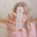 Child holding the Calming Essential Oil Roller carton out toward the camera