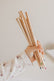Child's hand holding a bunch of the wooden affirmation pencils