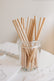 Affirmation pencils standing in a glass jar on a desk