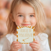 Girl holding an affirmation card reading I encourage my friends around me