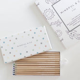 The open pencil box showing the affirmations printed along each pencil, beside a coloring book