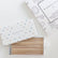 The open pencil box showing the affirmations printed along each pencil, beside a coloring book