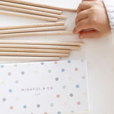 Affirmation pencils laid out beside the spotted box, showing messages including I can change the world