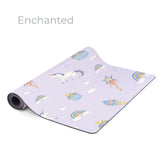 The Enchanted yoga mat in lilac, printed with unicorns, rainbows and clouds
