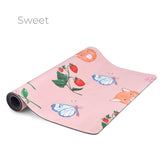 The Sweet yoga mat in pink, printed with strawberries, butterflies and a fox