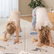 Two children in downward dog pose on yoga mats side by side
