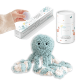 Teal octopus plush with a tube of magnesium calming soak and a hand lifting a bath fizzy from its box.