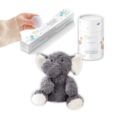 Gray elephant plush with a tube of magnesium calming soak and a hand lifting a bath fizzy from its box.
