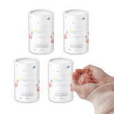 Four Magnesium Calming Soak tubs with a pair of hands holding bath salt crystals