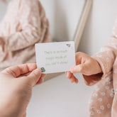 Adult handing a child a Love Note reading there is so much magic inside of you, let it shine