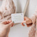 Adult handing a child a Love Note reading there is so much magic inside of you, let it shine