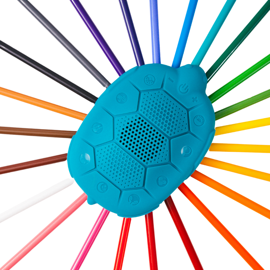 Zenimal Kids + and sleep sound machine to help kids sleep better, focus, and gain self regulation.  Zenimal Kids on a rainbow of colored pencils. 